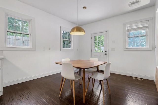 dining area featuring visible vents, baseboards, and dark wood-style flooring