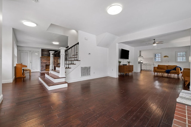 living room with dark hardwood / wood-style flooring and ceiling fan