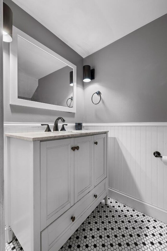 bathroom with vanity and wood walls