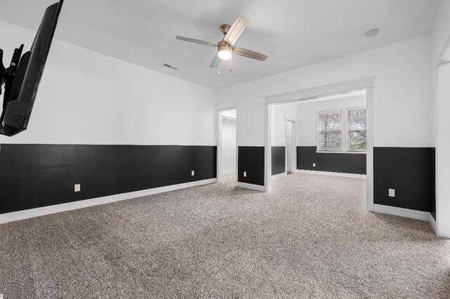 interior space with visible vents, baseboards, and a ceiling fan