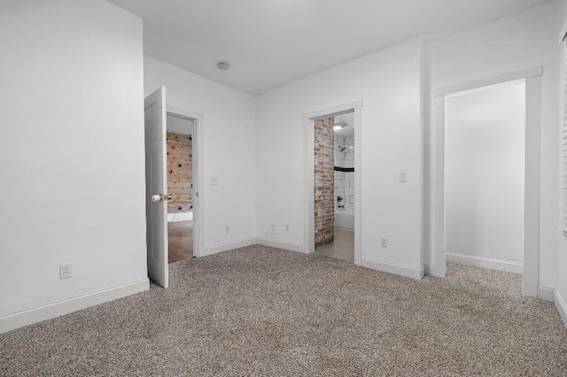 unfurnished bedroom with light colored carpet and connected bathroom