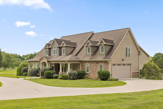 view of front of property featuring a front lawn, a garage, and driveway