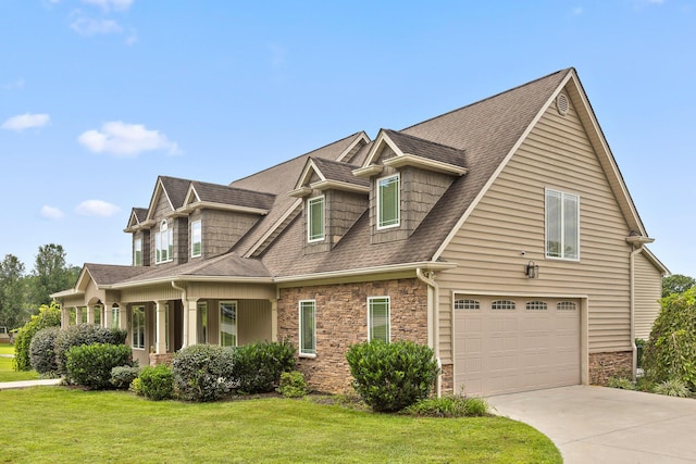 view of front of home featuring stone siding, a garage, and a front lawn