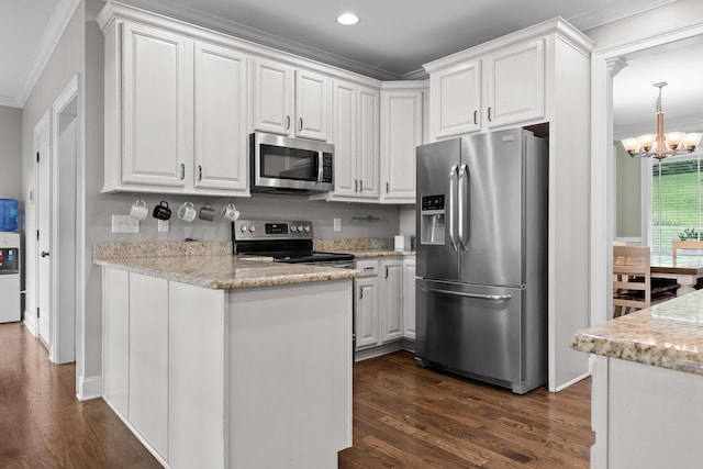 kitchen with crown molding, a chandelier, dark wood-style floors, white cabinets, and stainless steel appliances