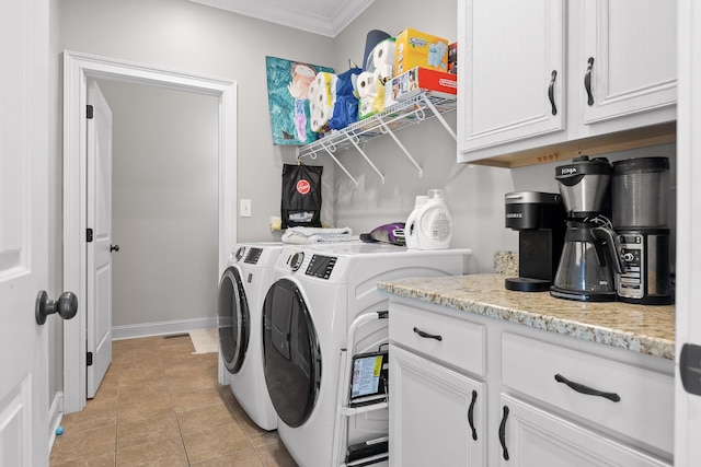 clothes washing area with crown molding, baseboards, light tile patterned floors, cabinet space, and separate washer and dryer