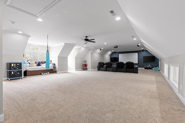 home theater room featuring visible vents, baseboards, lofted ceiling, carpet flooring, and recessed lighting