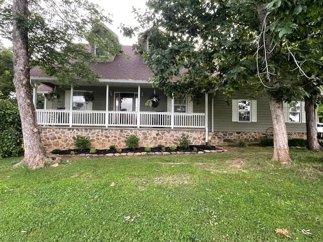 view of front of home with a front yard and covered porch