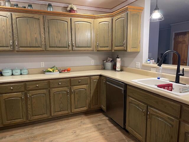 kitchen with pendant lighting, ornamental molding, sink, stainless steel dishwasher, and light hardwood / wood-style floors