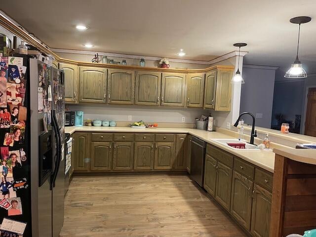 kitchen with pendant lighting, light hardwood / wood-style floors, stainless steel appliances, ornamental molding, and sink