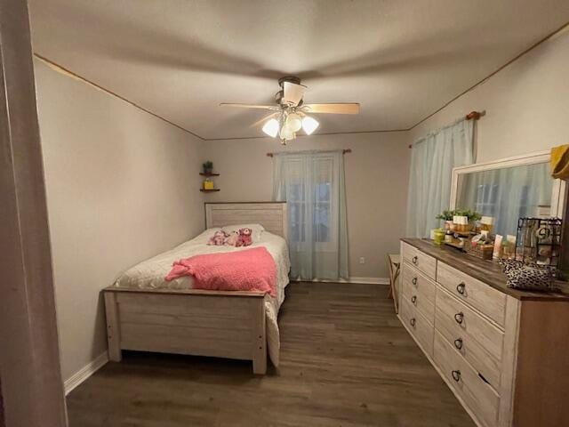 bedroom featuring ceiling fan and dark hardwood / wood-style flooring