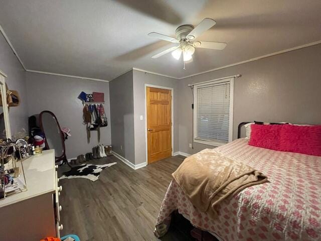 bedroom featuring ceiling fan, hardwood / wood-style flooring, and crown molding