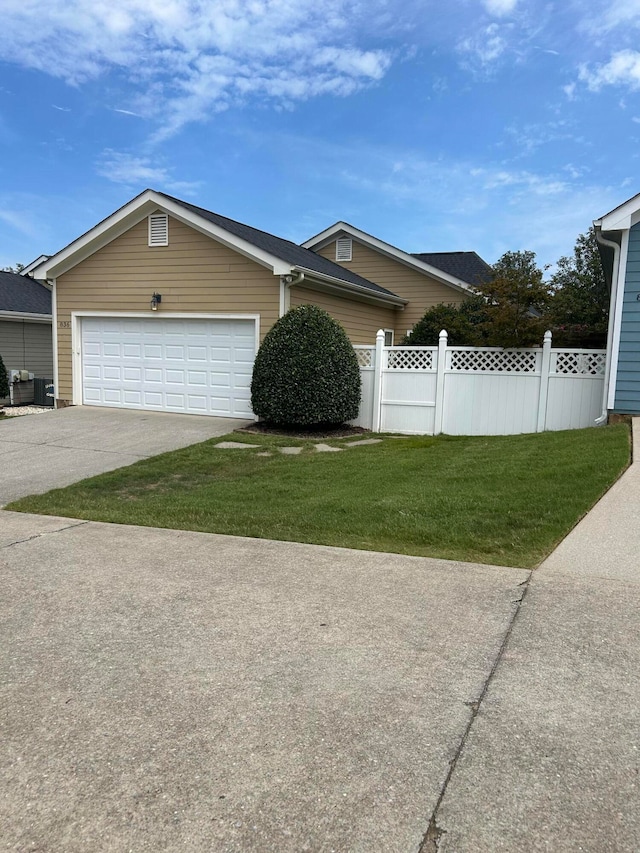 view of front of house featuring a garage and a front lawn