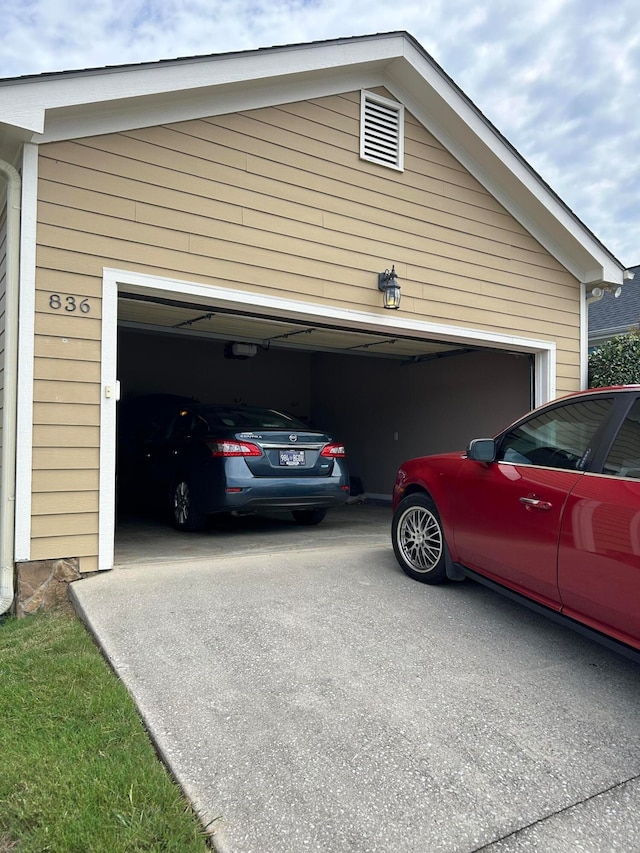 garage featuring a garage door opener and wooden walls