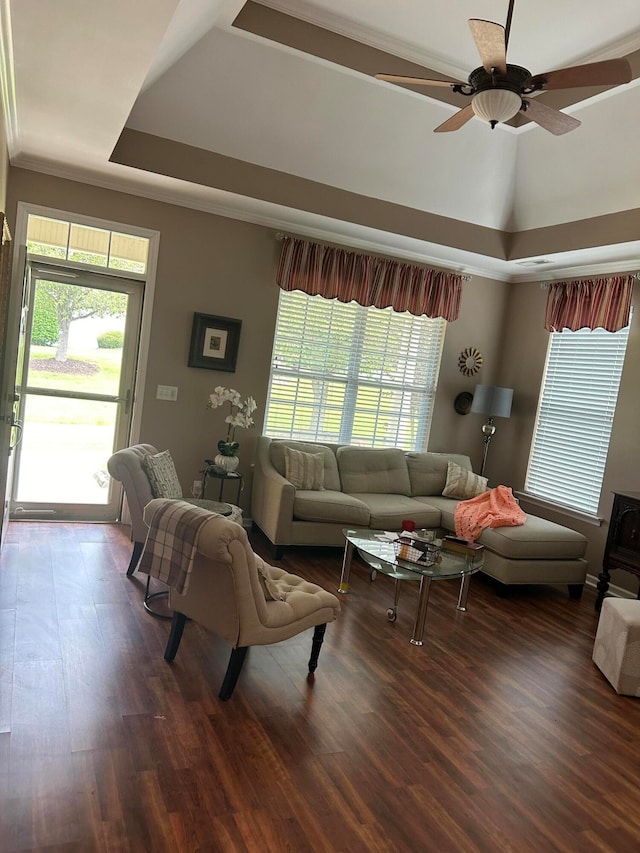 living room featuring ceiling fan, dark hardwood / wood-style floors, and a healthy amount of sunlight