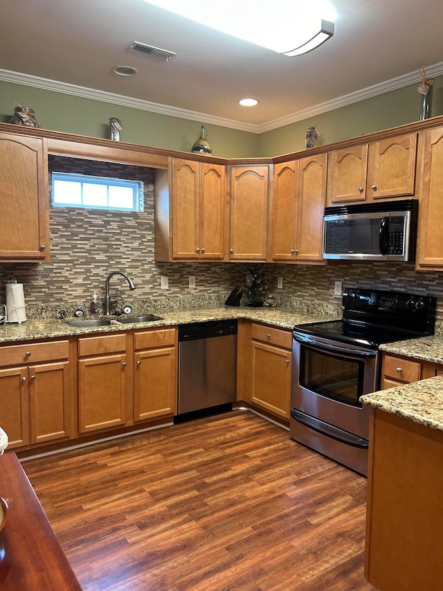 kitchen featuring ornamental molding, backsplash, sink, dark hardwood / wood-style floors, and appliances with stainless steel finishes