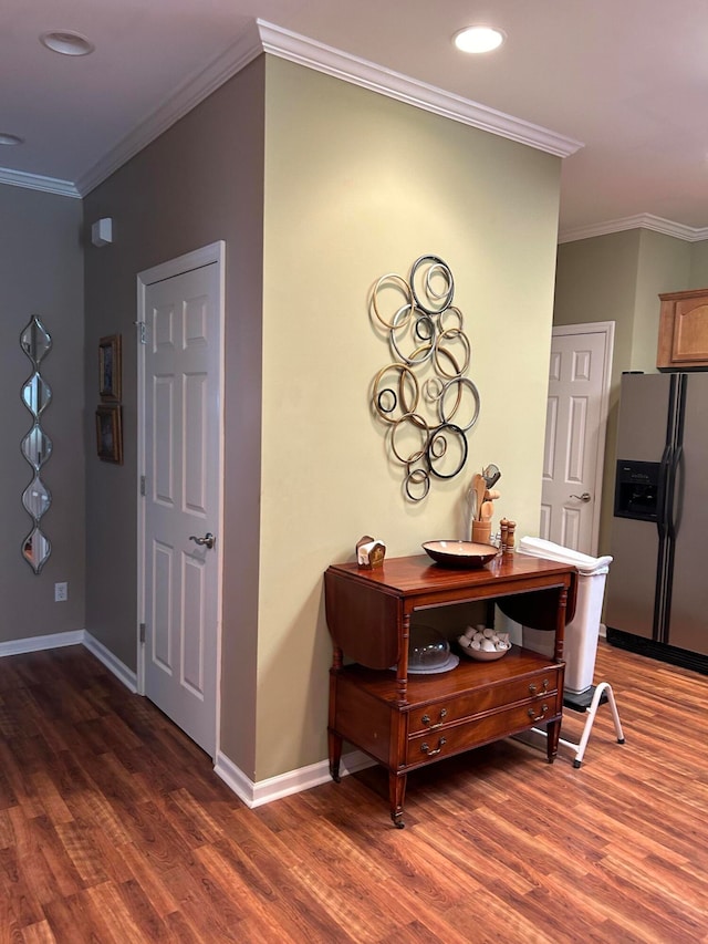 hall with crown molding and dark hardwood / wood-style flooring