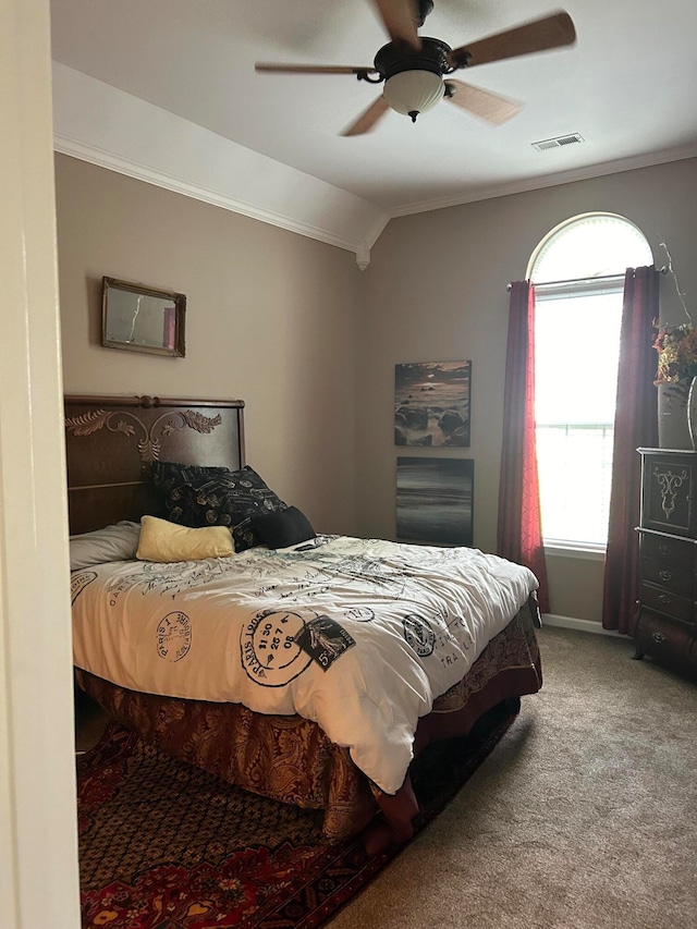 bedroom featuring carpet flooring, ceiling fan, ornamental molding, and vaulted ceiling