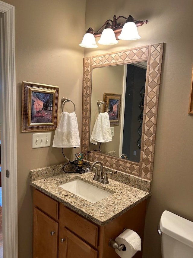 bathroom featuring toilet and vanity