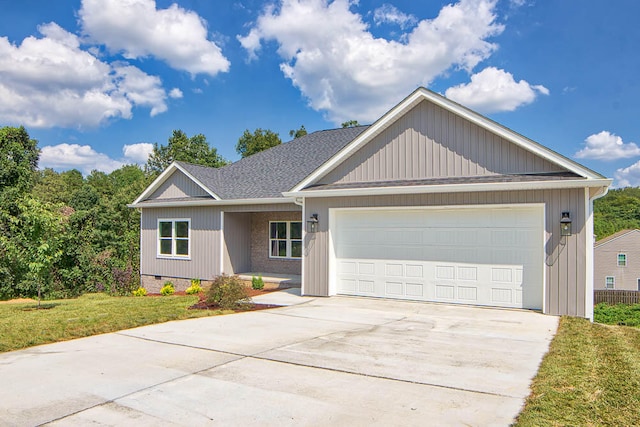 view of front of home featuring a front yard and a garage