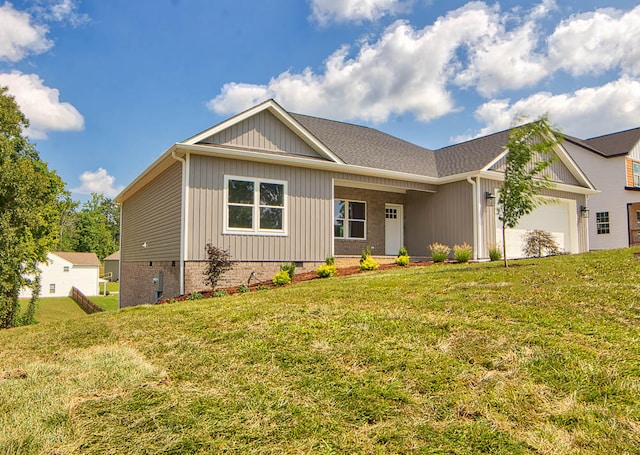 view of front of house with a front yard and a garage