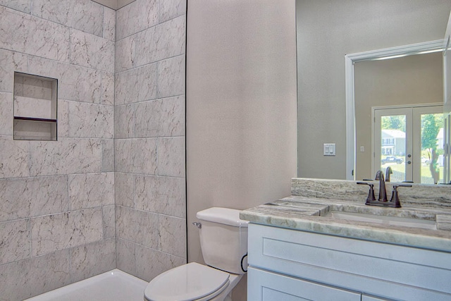 bathroom with vanity, toilet, and french doors