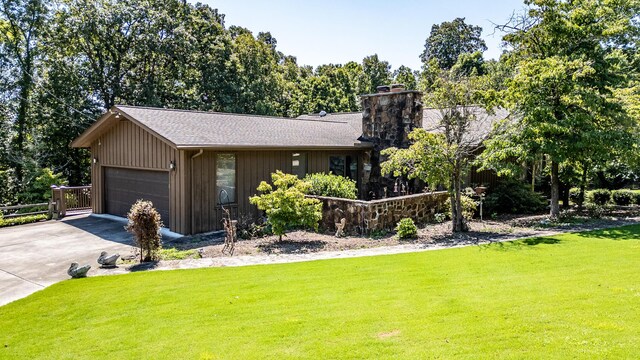 ranch-style house featuring a front yard and a garage