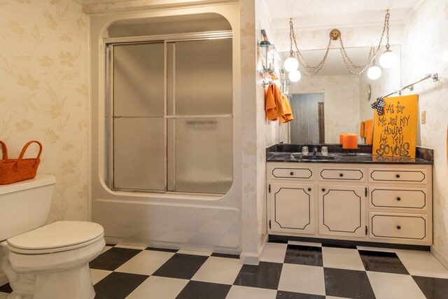 full bathroom with vanity, toilet, and bath / shower combo with glass door