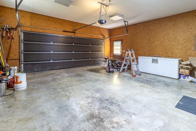 garage with a garage door opener and refrigerator