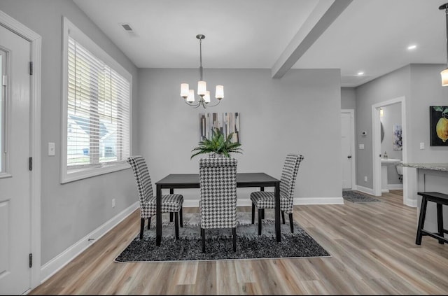 dining room featuring light hardwood / wood-style flooring and an inviting chandelier