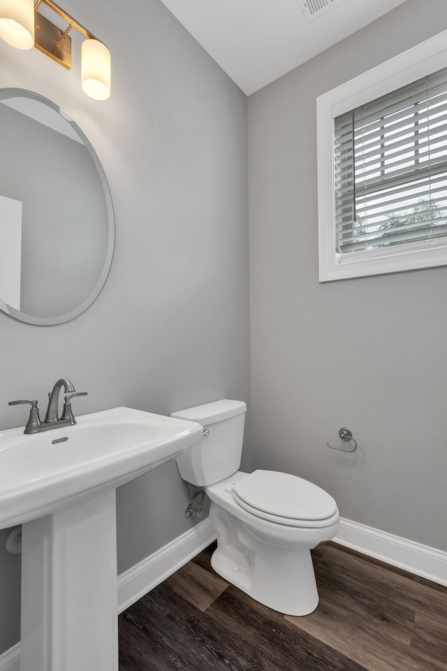 bathroom with toilet, hardwood / wood-style flooring, and sink