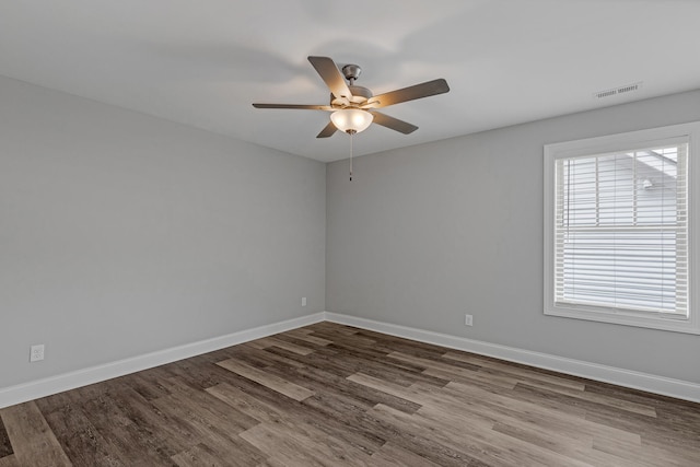 empty room with ceiling fan and hardwood / wood-style flooring