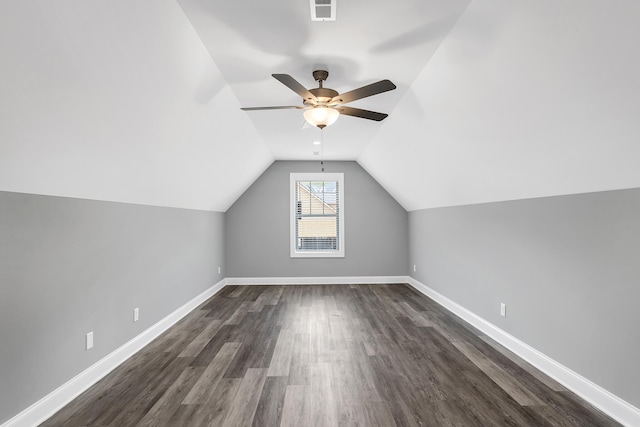 additional living space featuring dark wood-type flooring, ceiling fan, and vaulted ceiling