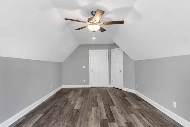 additional living space with dark wood-type flooring, vaulted ceiling, and ceiling fan