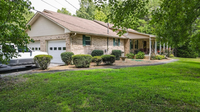 ranch-style house featuring a porch, a garage, and a front lawn