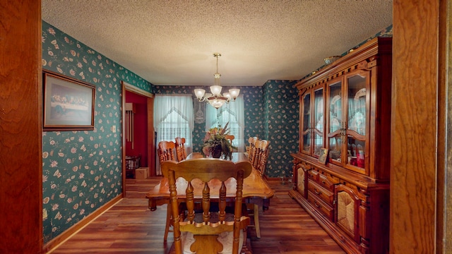 dining area with a chandelier, a textured ceiling, and hardwood / wood-style flooring