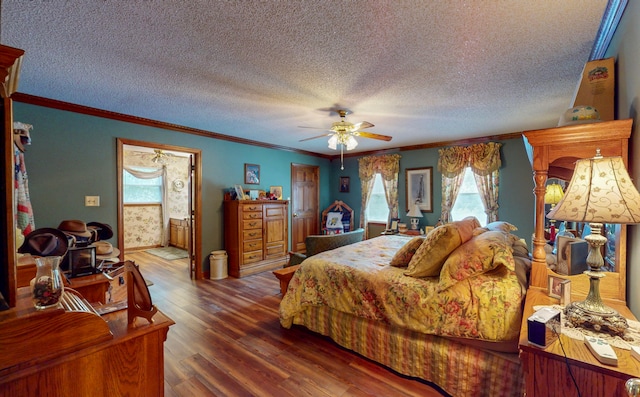 bedroom with a textured ceiling, ceiling fan, crown molding, and dark wood-type flooring