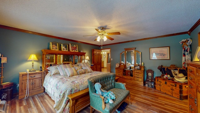 bedroom featuring a textured ceiling, ceiling fan, light wood-type flooring, and crown molding