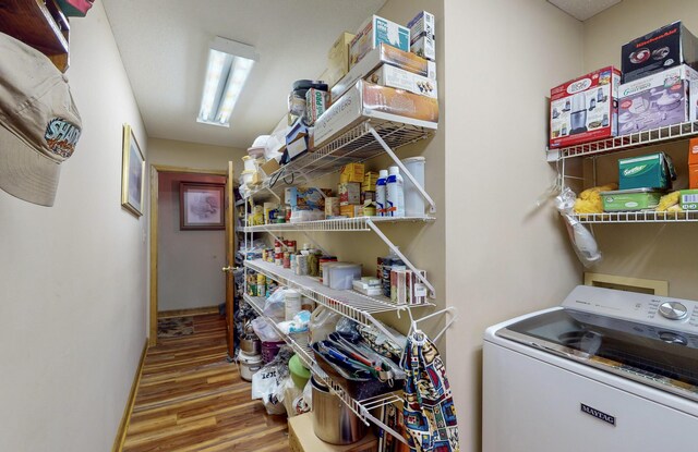 laundry room featuring washer / dryer and light wood-type flooring