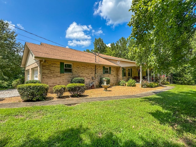 back of house with a lawn