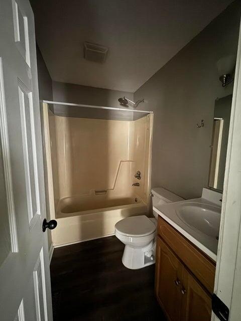 full bathroom featuring vanity, toilet, shower / tub combination, and wood-type flooring