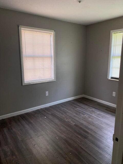 unfurnished room featuring dark hardwood / wood-style flooring