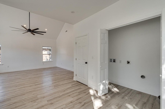 unfurnished room with ceiling fan, high vaulted ceiling, and light hardwood / wood-style floors