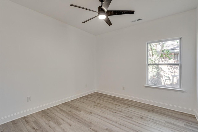 empty room featuring ceiling fan and light hardwood / wood-style flooring