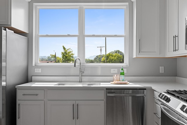 kitchen featuring plenty of natural light, sink, and appliances with stainless steel finishes