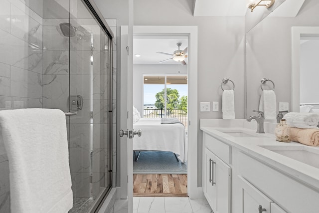 bathroom with vanity, ceiling fan, and an enclosed shower