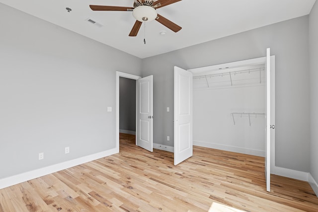 unfurnished bedroom with ceiling fan, a closet, and light hardwood / wood-style floors