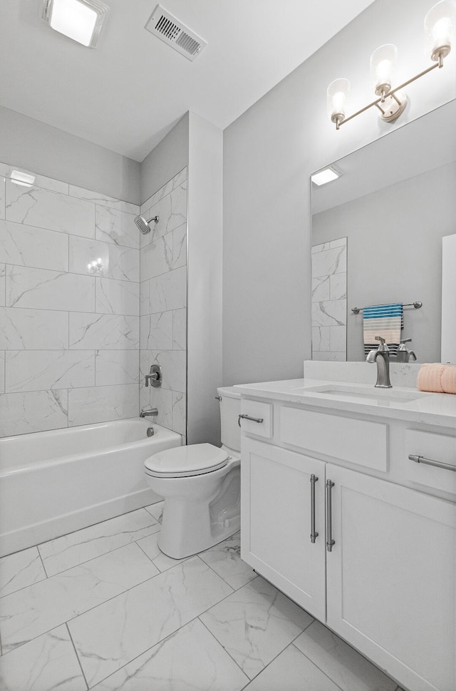 full bathroom with toilet, tiled shower / bath combo, and vanity