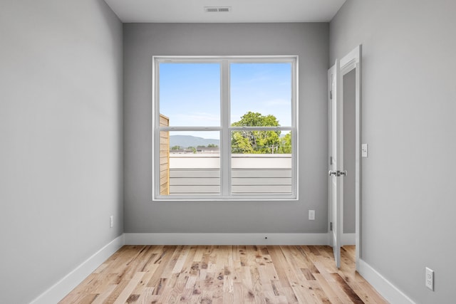 unfurnished room with light hardwood / wood-style flooring