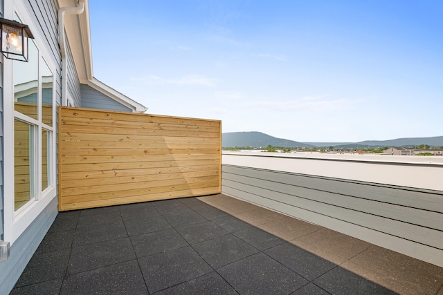 view of patio featuring a mountain view and a balcony