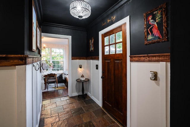 foyer entrance featuring crown molding, a chandelier, and dark hardwood / wood-style floors